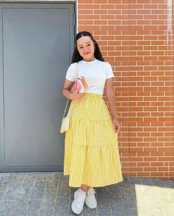 white tee paired with a yellow gingham midi skirt